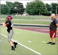  ?? MARK HUMPHREY ENTERPRISE-LEADER ?? Lincoln junior high head coach Beau Collins (right) supervises a recent scrimmage at Wolfpack Stadium. The junior Wolves open the season at home against border rival, Westville, Okla. on Thursday, Sept. 5.