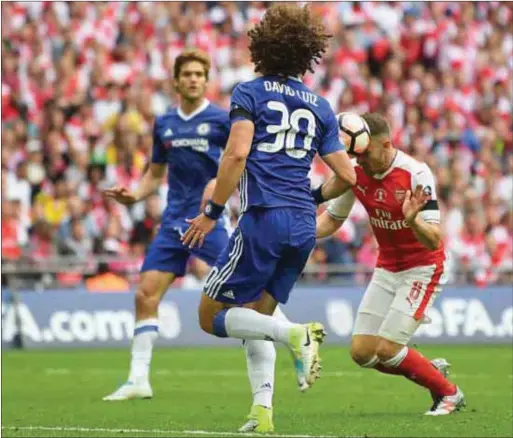  ??  ?? Ramsey (in red) scoring the winning goal for Arsenal yesterday