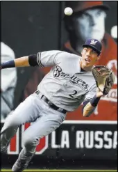  ?? Jeff Roberson The Associated Press ?? Brewers left fielder Christian Yelich prepares to catch a ball hit by Paul DeJong in the second inning of the Cardinals’ 7-2 win Saturday at Busch Stadium.