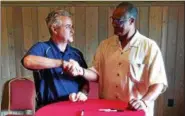  ??  ?? Assemblyma­n Steven McLaughlin, R-Troy, left, shakes hands with Baseball Hall of Famer Jim Rice during a Tuesday afternoon luncheon at the Desmond Hotel & Conference Center in Colonie held in advance of the 2017 New York-Penn League All-Star Game.