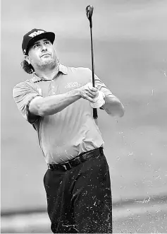  ?? — AFP photo ?? Pat Perez plays a fairway shot on the 15th hole during the second round of the CIMB Classic golf tournament in Kuala Lumpur.