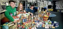  ?? DAVID UNWIN/STUFF ?? Newbury School pupils organised a food drive yesterday. From left are Phoenix Castell-spence, 11, Rebecca Clark, 13, and Quinn Collis, 13.