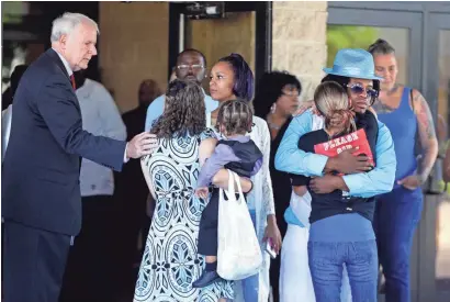  ?? RICK WOOD / MILWAUKEE JOURNAL SENTINEL ?? Mayor Tom Barrett offers his condolence­s to family members of 6-year-old Justin Evans Jr., who was shot and killed July 22 outside his grandmothe­r’s home. Funeral services were held at Holy Redeemer Church of God in Christ.