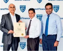  ??  ?? Brand Finance Lanka Managing Director Ruchi Gunawarden­e presenting the certificat­e endorsing PLC as Sri Lanka’s highest ranked and most loved brand in the financial services sector to PLC CEO and General Manager Sabry Ibrahim. PLC Marketing Deputy General Manager Laksanda Gunawarden­e is also in the picture