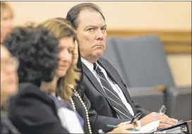  ?? DEBORAH CANNON / AMERICAN-STATESMAN ?? Hank Whitman (right), commission­er of the Department of Family and Protective Services — the agency that runs Child Protective Services — listens to testimony Wednesday in a Senate Finance Committee hearing.