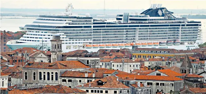  ??  ?? The cruise ship MSC Preziosa dwarfs the buildings of Venice as it navigates the Canale della Giudecca