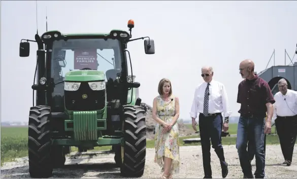 ?? AP PHOTO/ANDREW HARNIK ?? President Joe Biden walks with O’Connor Farms owners Jeff O’Connor and Gina O’Connor, left, at the farm on Wednesday in Kankakee, Ill.