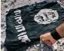  ?? ?? A Syrian fighter burns an Isis flag during battles in the country.