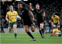  ??  ?? Julian Savea races in for one his two tries on Saturday, to the delight of All Blacks team-mate Ryan Crotty.