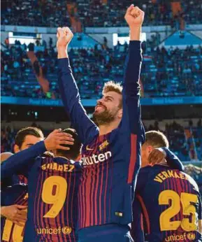  ?? AFP PIC ?? Barcelona’s Gerard Pique celebrates after teammate Aleix Vidal’s goal against Real Madrid during their La Liga match on Saturday.