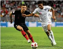  ?? DAN MULLAN / GETTY IMAGES ?? Marcus Rashford of England (right) is challenged by Dejan Lovren of Croatia during Wednesday’s match at Luzhniki Stadium. “Us players, now we change something and everyone is proud of us in Croatia, ” Lovren said.