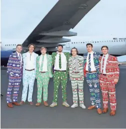  ??  ?? Clemson players show off their Christmas suits as they arrive at Phoenix Sky Harbor Executive Terminal Sunday for the PlayStatio­n Fiesta Bowl.