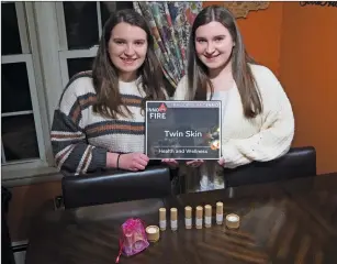  ?? Joseph B. Nadeau photo/The Call ?? North Smithfield High School seniors Kristianna, left, and Kate, right, Lapierre show the Inno on Fire Award they received for the Twin Skin lip care products company they founded while still in school. The business was among 29 small businesses and startups highlighte­d by Rhode Island Inno on Fire at its recent annual award ceremony.