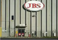  ?? (AP Photo/David Zalubowski, File) ?? FILE - A worker heads into the JBS meatpackin­g plant in Greeley, Colo., on Oct. 12, 2020.