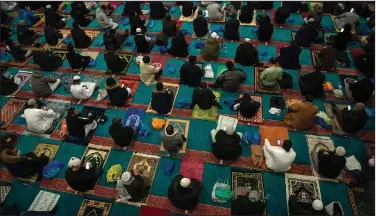  ?? (AP/Aaron Chown) ?? Worshipers gather for a Ramadan service Wednesday at a mosque in east London after the holy month had to be observed last year without the usual community prayer gatherings.