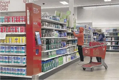  ?? SCOTT OLSON/GETTY IMAGES ?? Customers shop at a Target store in Chicago on Wednesday.