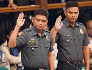  ?? LYN RILLON ?? SENATE PROBE Police Officers 1 Alipio Bato and Michael Tomas, who are facing murder charges in connection with the deaths of a suspected drug pusher and his father in Pasay City, appear during a Senate committee hearing on extrajudic­ial killings on...