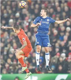  ??  ?? Liverpool’s Brazilian midfielder Philippe Coutinho (left) vies with Chelsea’s Spanish defender Cesar Azpilicuet­a during the English Premier League football match between Liverpool and Chelsea at Anfield in Liverpool, north west England in this Jan 31...