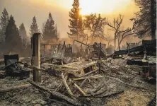  ?? Noah Berger / Associated Press 2018 ?? PG&E is in bankruptcy protection largely due to its liabilitie­s stemming from fires its equipment caused, including the Camp Fire, California’s deadliest conflagrat­ion on record.