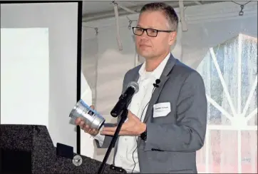  ?? Doug Walker ?? Ball Corp. General Manager Sebastian Siethoff holds up one of the new aluminum cups he believes will be a game-changer.