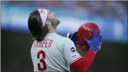  ?? BEN MARGOT — THE ASSOCIATED PRESS ?? Philadelph­ia Phillies’ Bryce Harper prepares to put his batting helmet back on in the fourth inning of a baseball game against the San Francisco Giants Sunday in San Francisco.