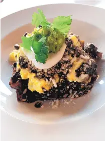  ??  ?? Mole chilaquile­s is one of the dishes served up at newly opened Zacatlán on Aztec Street.