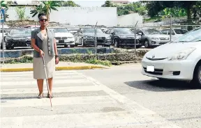  ?? KENYONHEMA­NS/PHOTOGRAPH­ER ?? Camile Wilson crossing a major road in the Corporate Area.