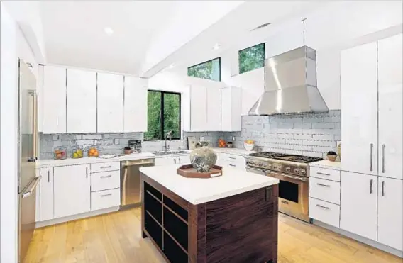  ?? Photograph­s courtesy of Total Agent ?? AFTER: A large parcel allowed for the home’s expansion to 4,300 square feet; the kitchen benefited from the $1.3-million overhaul.