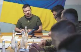  ?? UKRAINIAN PRESIDENTI­AL PRESS OFFICE ?? Ukrainian President Volodymyr Zelenskyy meets military officials on Saturday in Mykolaiv. Zelenskyy also met staff at a city hospital and troops.