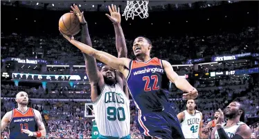  ?? AP/CHARLES KRUPA ?? Washington forward Otto Porter (right) has his shot blocked from behind by Boston defender Amir Johnson during Game 2 of their NBA Eastern Conference semifinal Tuesday. The Celtics grabbed a 2-0 series lead by beating the Wizards 129-119.