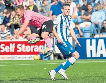  ??  ?? Caley Thistle’s Scott Allardice takes to the air as Killie’s Blair Alston looks on