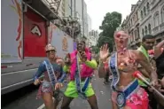  ?? AP PHOTO/BRUNA PRADO ?? Below: Revelers dance alongside a sound truck Jan. 27 in Rio de Janeiro, Brazil.