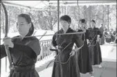  ?? PROVIDED TO CHINA DAILY ?? Students at United Internatio­nal College learn Chinese archery in an elective class.