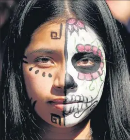  ?? REUTERS ?? THE FACE OF RESISTANCE: A climate change protester with her face painted is pictured during a rally at the Youth Climate Strike in Los Angeles on Friday.