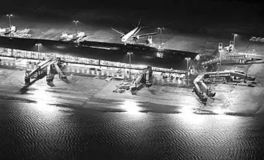  ??  ?? A flooded runway at Kansai airport. (Photo: Reuters)