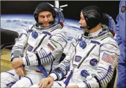  ?? DMITRI LOVETSKY / ASSOCIATED PRESS ?? U.S. astronaut Nick Hague (right) and Russian cosmonaut Alexey Ovchinin speak prior to the launch of Soyuz rocket at the Russian-leased Baikonur cosmodrome in Kazakhstan on Thursday.