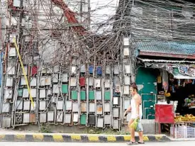  ?? —NIÑO JESUS ORBETA ?? HEAVY USERS A jungle of wires and meters greets passersby in Payatas, Quezon City, an area with high electricit­y consumptio­n and directly affected by movements in power rates.