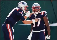  ?? Adam Hunger / Associated Press ?? New England Patriots running back Damien Harris (37) celebrates a touchdown with quarterbac­k Mac Jones against the New York Jets last Sunday.