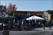  ??  ?? Crowds wait patiently to get into Rise and Redemption during Vacaville’s Small Business Saturday event.