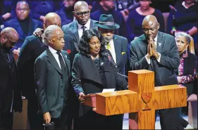  ?? ANDREW NELLES / THE TENNESSEAN VIA AP, POOL ?? Flanked by the Rev. Al Sharpton, left, husband, Rodney Wells, second from right, and attorney Benjamin Crump, right, Rowvaughn Wells speaks Wednesday during the funeral service for her son Tyre Nichols at Mississipp­i Boulevard Christian Church in Memphis, Tenn. Nichols died as a result of a brutal beating by Memphis police after a traffic stop last month.