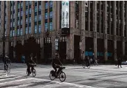  ?? Lea Suzuki/The Chronicle 2022 ?? Bicyclists ride past Twitter headquarte­rs, at 1355 Market St. in San Francisco, in November.