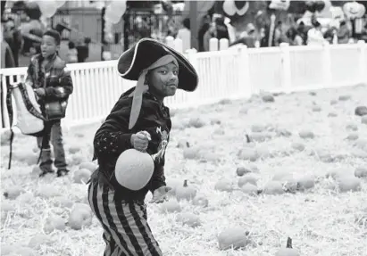  ?? KIM HAIRSTON / BALTIMORE SUN PHOTOS ?? Keyon Johnson, 7, of Park Heights, brings some pirate swagger to the annual Sandtown Halloween Festival. He and other children who attended picked pumpkins from a makeshift pumpkin patch and collected candy.