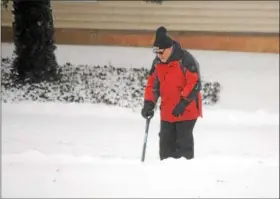  ?? GENE WALSH — DIGITAL FIRST MEDIA ?? A man works to clear snow piled high in a driveway in Trappe Thursday.