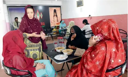  ?? AFP ?? Hameeda Ali Hazara, who is from the ethnic minority Hazara community and runs the ‘Hazara’ restaurant, chats with customers at the eatery in Hazara Town, a neighbourh­ood in Quetta. —