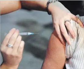  ?? CANADIAN PRESS FILE PHOTO ?? A person gets a shot during a flu vaccine program. The effectiven­ess of this year’s flu shot is being reported as under 20 per cent for the dominant strain.