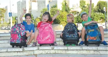  ??  ?? HAPPILY POSING with her friends, Hallel (second from left) is completing first grade at a mainstream school in Jerusalem’s Old City despite her disabiliti­es.