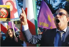  ?? (Tony Gentile/Reuters) ?? OPPONENTS OF Iran’s President Hassan Rouhani protest outside the Iranian Embassy in Rome yesterday.