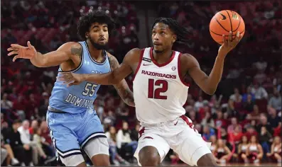  ?? (NWA Democrat-Gazette/Andy Shupe) ?? Arkansas guard Tramon Mark (12) drives to the lane Nov. 13 past Old Dominion guard Bryce Baker (55) during the second half of his team’s 86-77 win at Walton Arena in Fayettevil­le.