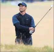  ?? Sam Greenwood Getty Images ?? TIGER WOODS made the cut with a pair of 71s, leaving him six shots back going into the weekend.