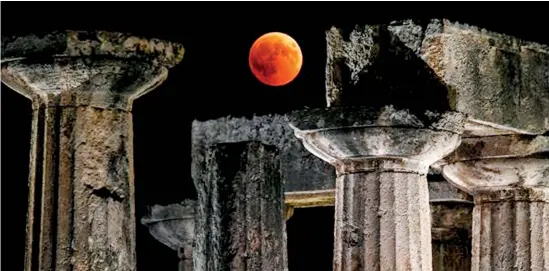  ??  ?? In this file photo taken on July 27 the full moon is seen during a “blood moon” eclipse over the temple of Apollo in Corinth. The Internatio­nal Monetary Fund on July 31 urged Greece to be “realistic” about its economic goals, and reiterated the longstandi­ng concern the country may yet need additional debt relief. The IMF board welcomed the agreement Athens reached with the European Union in June to reduce the country's debt burden over the next five to 10 years but said it may be insufficie­nt given the potential for political opposition to further reforms. / AFP PHOTO